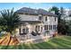 Back of the house with a spacious deck, lounge chairs, and a well-kept lawn at 3845 Overlake Dr, Cumming, GA 30041