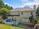 A well maintained back yard with a two story home and deck, surrounded by lush trees at 3845 Overlake Dr, Cumming, GA 30041