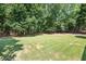 Large backyard with mature trees provides a serene and private outdoor setting at 3845 Overlake Dr, Cumming, GA 30041