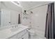 Clean bathroom with a shower-tub combo, white tile, and modern vanity at 3845 Overlake Dr, Cumming, GA 30041