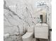 Elegant bathroom featuring marble walls and floors, modern toilet, and sleek vanity at 3845 Overlake Dr, Cumming, GA 30041