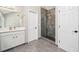 Bathroom featuring tiled walk-in shower with glass enclosure, vanity, and modern fixtures at 3845 Overlake Dr, Cumming, GA 30041