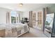 Bright bedroom featuring large windows, French doors, and a cozy quilt-covered bed at 3845 Overlake Dr, Cumming, GA 30041