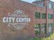 Brick building facade in Cumming City Center with large signage and black window frames at 3845 Overlake Dr, Cumming, GA 30041