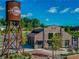 Exterior view of Cumming City Center with a water tower, brick building, and landscaped grounds at 3845 Overlake Dr, Cumming, GA 30041
