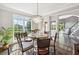 Bright dining room with hardwood floors, a chandelier, and a view to the green yard at 3845 Overlake Dr, Cumming, GA 30041