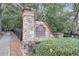 Stone entrance sign for the Highlands community featuring lush green landscaping and black fence at 3845 Overlake Dr, Cumming, GA 30041