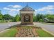 Community entrance sign with stone base and manicured flower beds, under a cloudy blue sky at 3845 Overlake Dr, Cumming, GA 30041