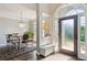 Inviting entryway with hardwood floors, a modern chandelier, and dining room view at 3845 Overlake Dr, Cumming, GA 30041