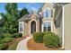 Charming home featuring manicured landscaping, stone accents, arched windows, and black shutters at 3845 Overlake Dr, Cumming, GA 30041