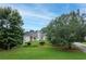 Inviting two-story home with arched windows, a stone entryway, and a well-maintained lawn at 3845 Overlake Dr, Cumming, GA 30041