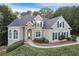 Charming two-story home with manicured landscaping, stone accents, and a welcoming walkway at 3845 Overlake Dr, Cumming, GA 30041