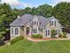 Charming home featuring manicured landscaping, stone accents, arched windows, and black shutters at 3845 Overlake Dr, Cumming, GA 30041