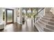 Elegant foyer with hardwood floors, staircase, and a view of the bright, airy living room at 3845 Overlake Dr, Cumming, GA 30041