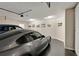 Spacious garage featuring black epoxy floors and decorated with car pictures at 3845 Overlake Dr, Cumming, GA 30041