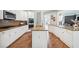Bright kitchen features granite countertops, stainless steel appliances, white cabinets, and an island at 3845 Overlake Dr, Cumming, GA 30041