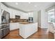 Bright kitchen features white cabinetry, stainless steel appliances, granite countertops and a functional center island at 3845 Overlake Dr, Cumming, GA 30041