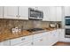 Bright kitchen with granite countertops, gas cooktop, white cabinets, and stainless steel microwave at 3845 Overlake Dr, Cumming, GA 30041