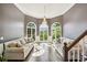 Bright living room with a high ceiling, hardwood floors, large windows, and a chandelier at 3845 Overlake Dr, Cumming, GA 30041