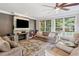Comfortable living room features a decorative fireplace, large TV, and hardwood floors at 3845 Overlake Dr, Cumming, GA 30041