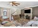 Comfortable living room features a decorative fireplace, large TV, and hardwood floors at 3845 Overlake Dr, Cumming, GA 30041