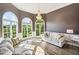 Bright living room with a high ceiling, hardwood floors, large windows, and a chandelier at 3845 Overlake Dr, Cumming, GA 30041