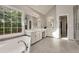 Bright bathroom features a soaking tub, a dual sink vanity, and large window views at 3845 Overlake Dr, Cumming, GA 30041