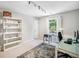 Home office featuring a modern desk, ample shelving, and a window overlooking the backyard at 3845 Overlake Dr, Cumming, GA 30041