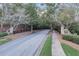 Scenic street view of the Highlands community with stone entrance signs, a black fence, and tree-lined sidewalks at 3845 Overlake Dr, Cumming, GA 30041
