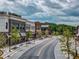 A street lined with mixed-use buildings, trees, and sidewalks in Cumming City Center at 3845 Overlake Dr, Cumming, GA 30041