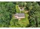 Aerial view of a home featuring a spacious backyard and a wooden deck surrounded by lush greenery at 7680 Banks Mill Road Rd, Douglasville, GA 30135