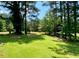 Large, luscious backyard with mature trees and green grass at 7680 Banks Mill Road Rd, Douglasville, GA 30135