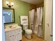 Bathroom featuring a vanity, toilet, and shower with decorative tiling and curtain at 7680 Banks Mill Road Rd, Douglasville, GA 30135
