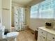 Bathroom featuring a tub and shower combination, floral shower curtain, toilet and sink at 7680 Banks Mill Road Rd, Douglasville, GA 30135