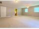 Spacious bedroom with neutral carpeting, a ceiling fan, and two large windows at 7680 Banks Mill Road Rd, Douglasville, GA 30135
