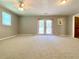 Large bedroom with neutral carpeting, bright lighting, and access to the backyard at 7680 Banks Mill Road Rd, Douglasville, GA 30135