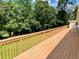Exterior view of long wood deck overlooking a large, green, wooded back yard at 7680 Banks Mill Road Rd, Douglasville, GA 30135