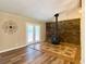 Cozy living room featuring a stone accent wall with a modern wood-burning stove at 7680 Banks Mill Road Rd, Douglasville, GA 30135
