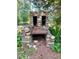 Rustic stone outdoor fireplace featuring two vents and a metal grate for grilling at 7680 Banks Mill Road Rd, Douglasville, GA 30135