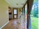 Bright sunroom with views of the backyard, tile flooring, and neutral-toned curtains at 7680 Banks Mill Road Rd, Douglasville, GA 30135