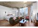 Spacious bedroom area with hardwood floors, city views, living room, and in-unit laundry at 860 Peachtree St # 1103, Atlanta, GA 30308