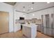Modern kitchen has stainless appliances, white cabinets, quartz counters, and kitchen island at 860 Peachtree St # 1103, Atlanta, GA 30308