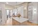 Open concept living space with hardwood floors, modern lighting, and exposed concrete ceiling at 860 Peachtree St # 1103, Atlanta, GA 30308