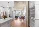 Open concept living space with hardwood floors, modern lighting, and exposed concrete ceiling with city views at 860 Peachtree St # 1103, Atlanta, GA 30308