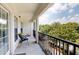 Exterior view of the balcony that overlooks mature trees and blue skies at 3275 Lenox Ne Rd # 413, Atlanta, GA 30324