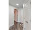 Hallway view with an open door to a bathroom and wood floors at 3275 Lenox Ne Rd # 413, Atlanta, GA 30324