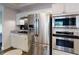 Kitchen featuring stainless steel appliances, white cabinets and black tiled backsplash at 3275 Lenox Ne Rd # 413, Atlanta, GA 30324