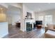Open living room with fireplace, dining area, and access to kitchen at 3275 Lenox Ne Rd # 413, Atlanta, GA 30324