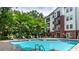 Beautiful community pool surrounded by lush greenery and comfortable lounge chairs for residents at 3275 Lenox Ne Rd # 413, Atlanta, GA 30324