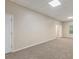 Spacious carpeted basement with neutral walls, drop ceiling, and two doors at 7420 Bristol Cir, Douglasville, GA 30134